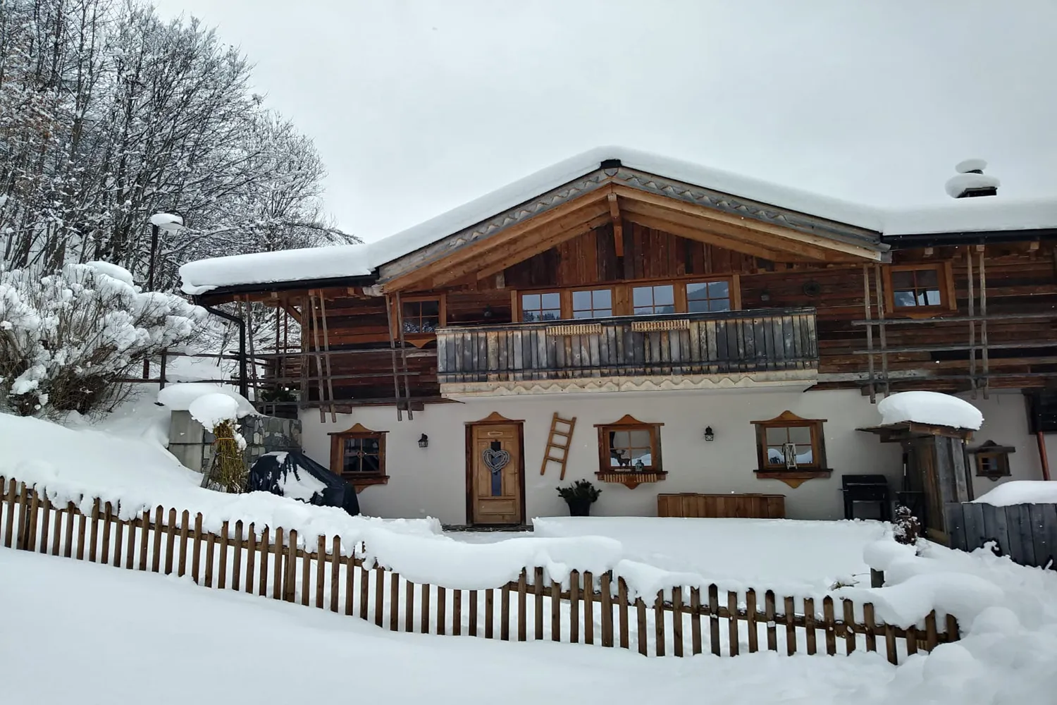 Almchalet Schneeberg im Schnee mit Holzzaun in Mühlbach am Hochkönig